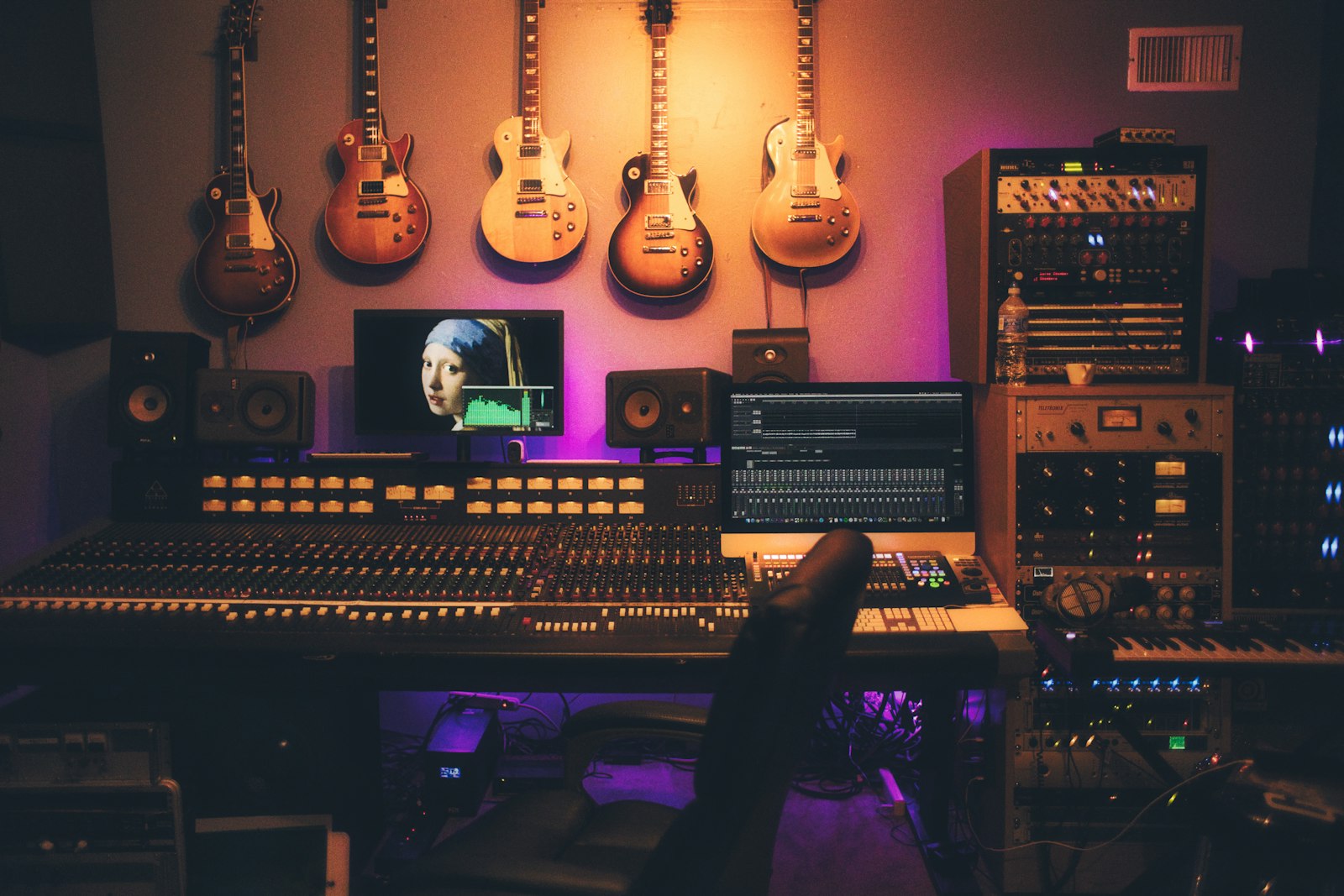 A studio mixing desk and monitors